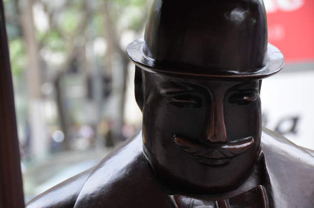 Sculpture of a British Fat cat gentleman outside the City Supermarket Shopping Centre near Jing'An Temple