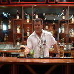 He gets some education about Bacardi Rum and learns to mix some drinks from the bartender Charlie during his tour