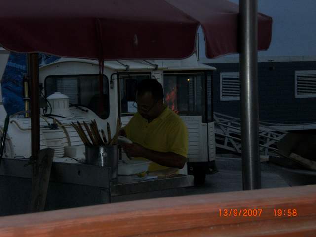 Man putting my dinner on a stick