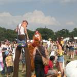 Crazy stilt man and chicken