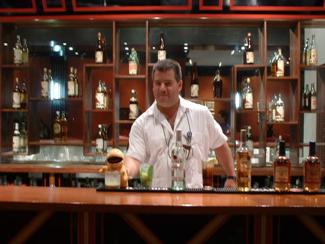 He gets some education about Bacardi Rum and learns to mix some drinks from the bartender Charlie during his tour