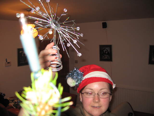 Ali putting the star on the tree