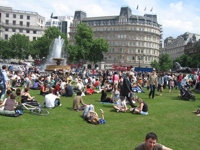 People enjoying Trafalar Sq. Green