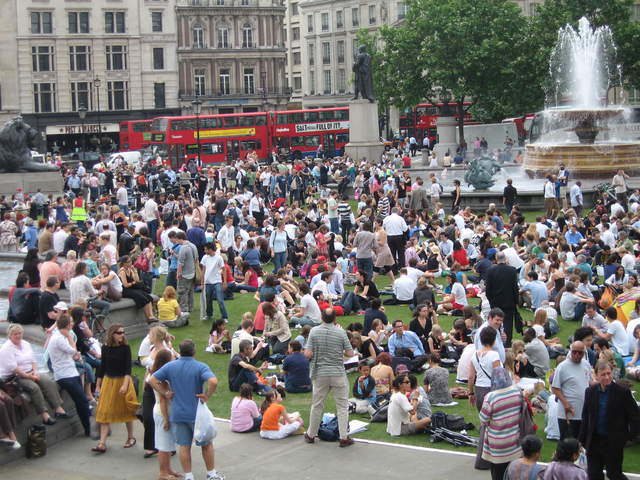 People enjoying Trafalar Sq. Green