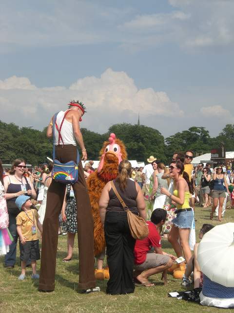 Crazy stilt man and chicken