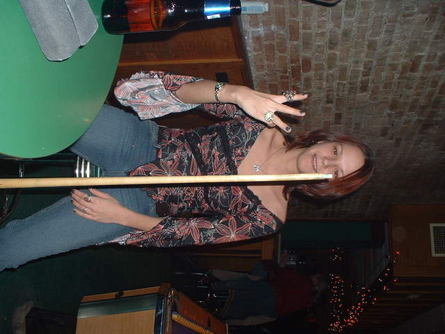 Liz balances a cue stick